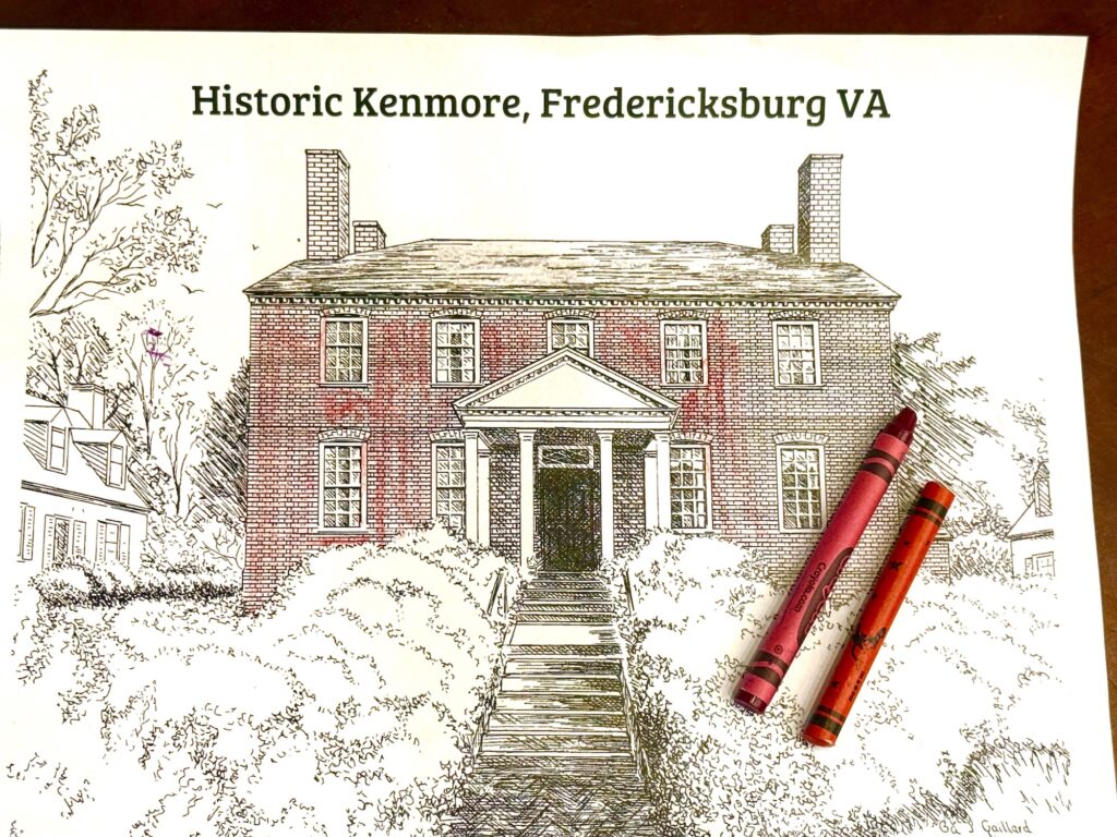 A partially colored drawing of Historic Kenmore in Fredericksburg, VA, with two crayons, one red and one orange, lying on the paper&mdash;a creative glimpse at things to do in Fredericksburg with kids.