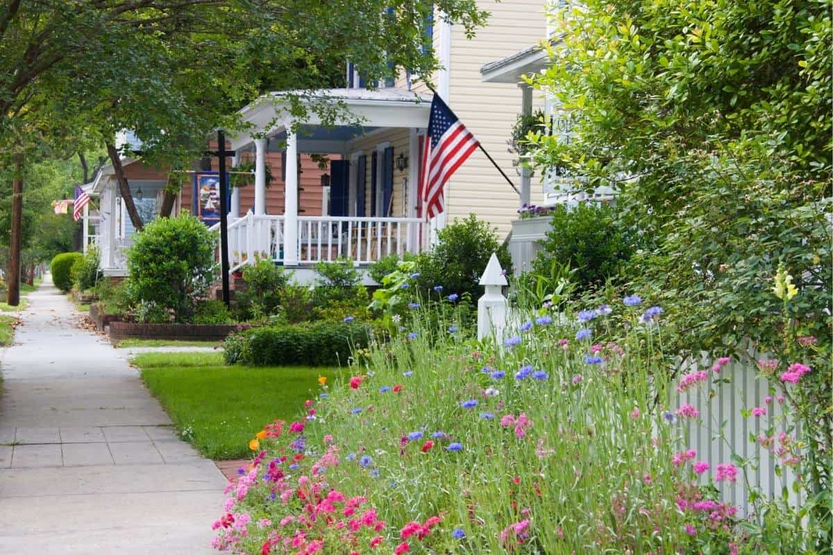 sidewalk facing homes with american flag