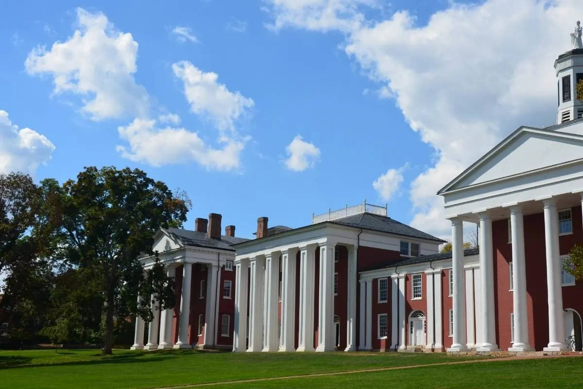 brick building with white columns on campus
