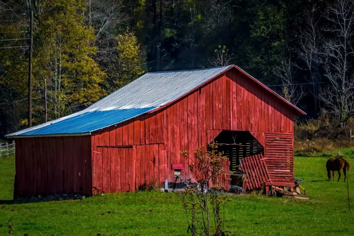 old red barn in green field