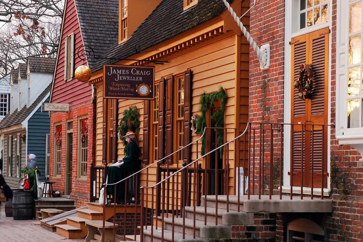 colonial street with apple and greenery wreaths on door