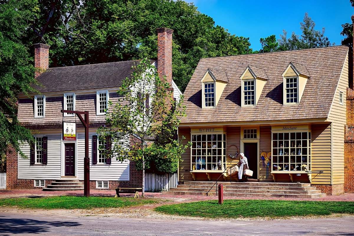 2 small colonial houses on dirt road