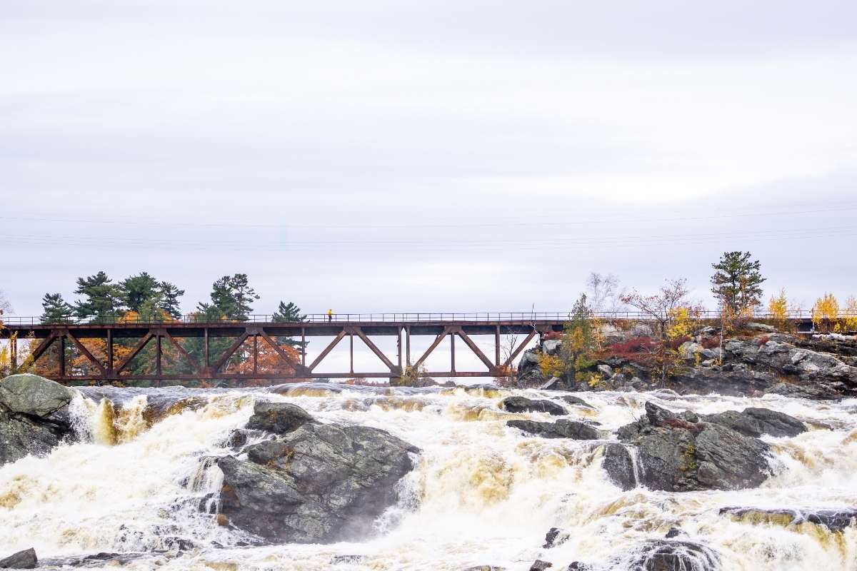 bridge over rocks and waterfall