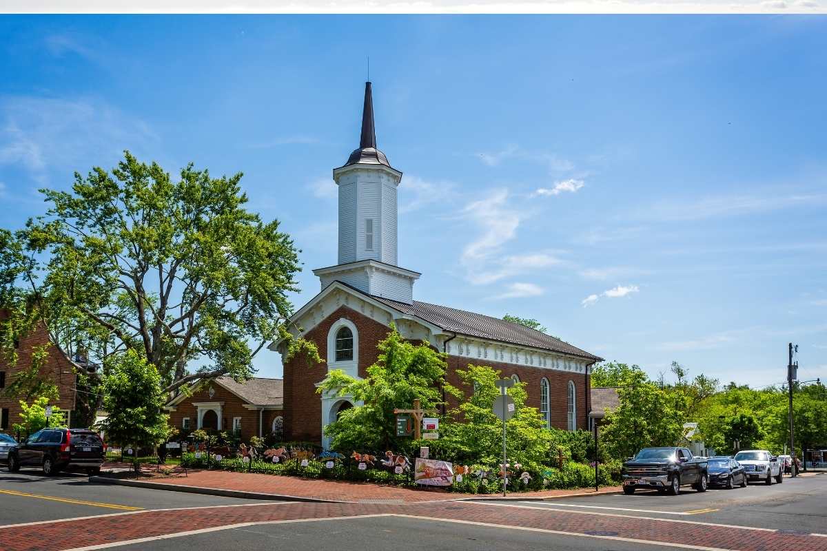 historic brick church surrounded by trees