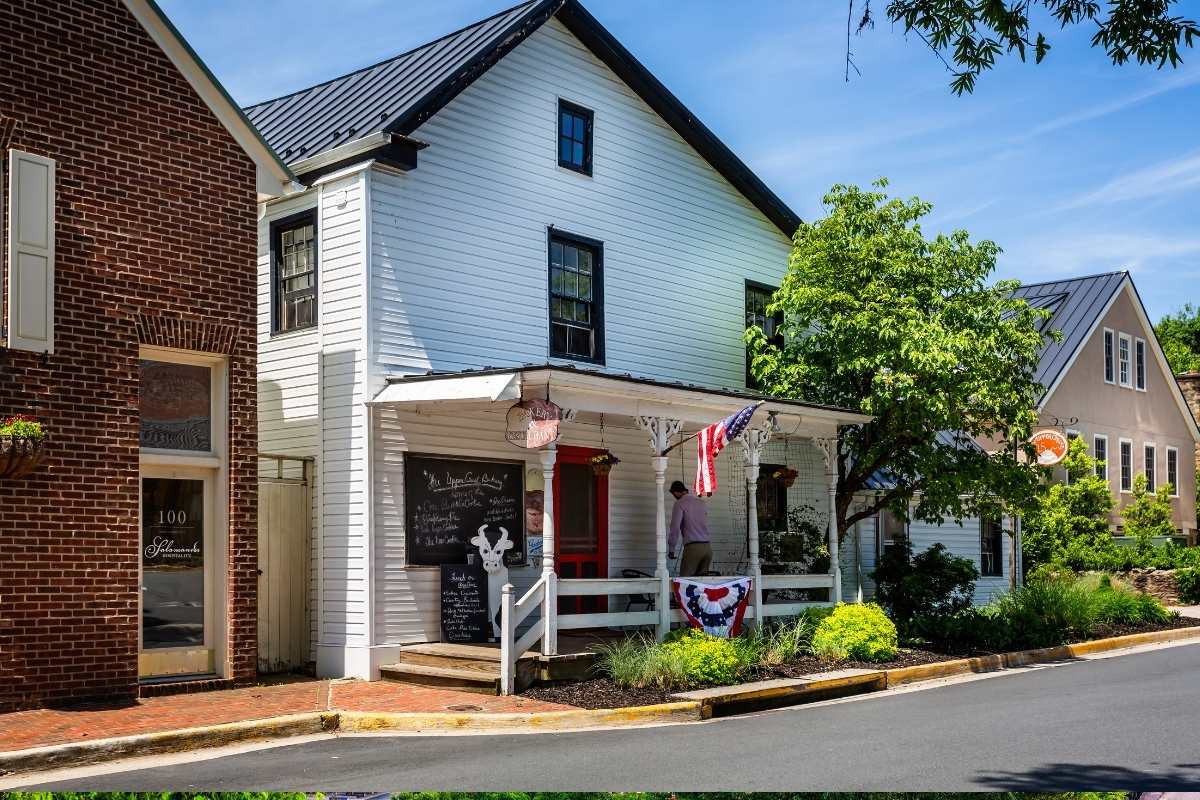 white house on main street with front porch and american flag