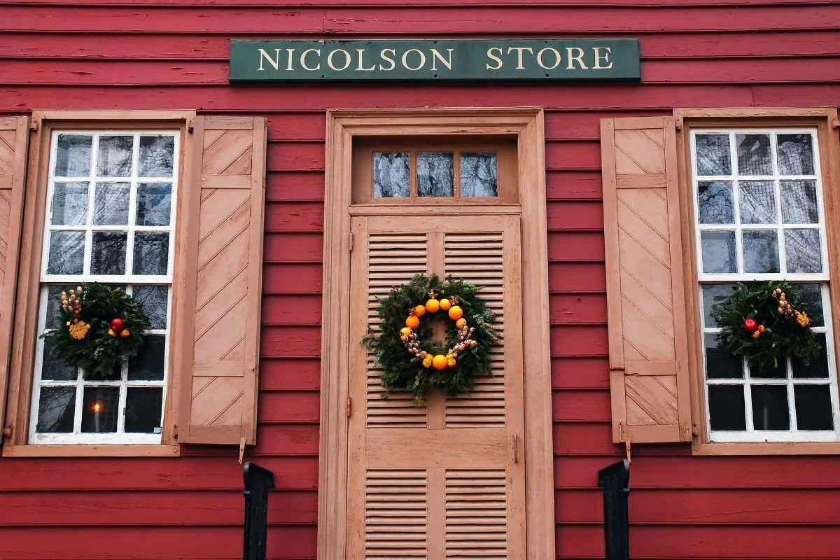 red house with wreaths on door and window