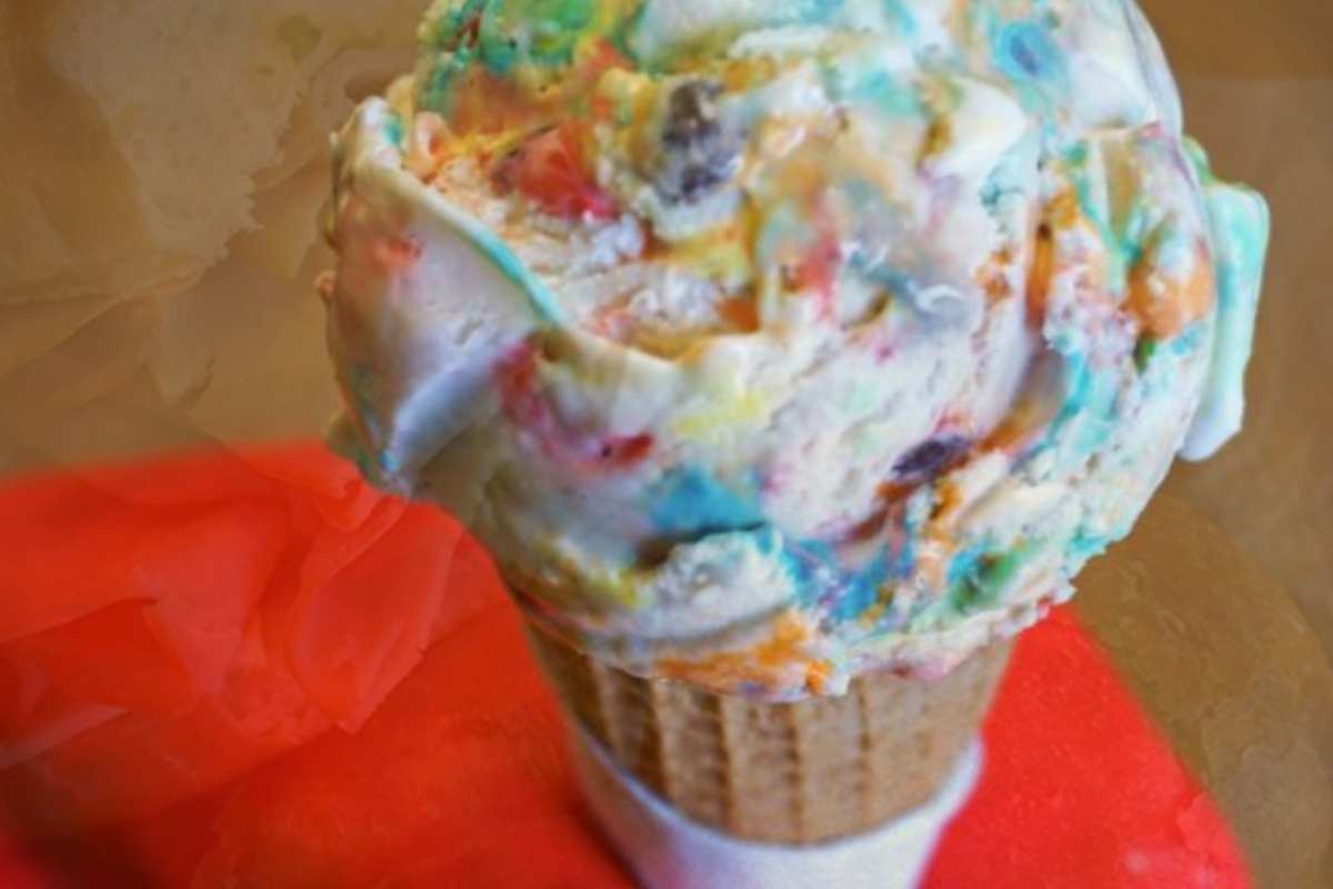 scoop of ice cream in cone with rainbow swirls