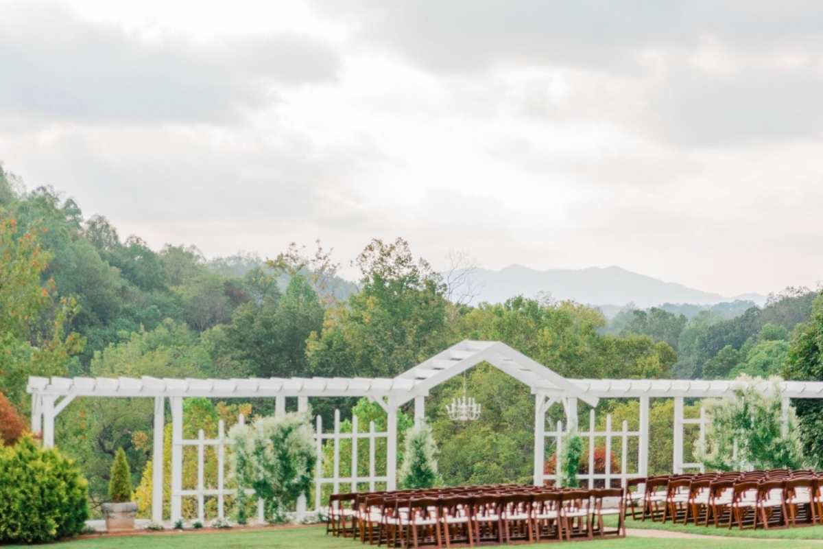 outdoor wedding ceremony with mountains in background