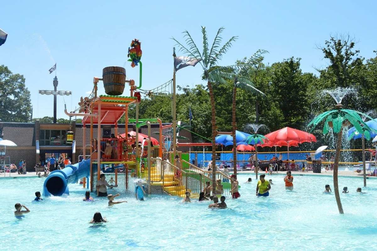 outdoor waterpark with slides and plastic palm trees