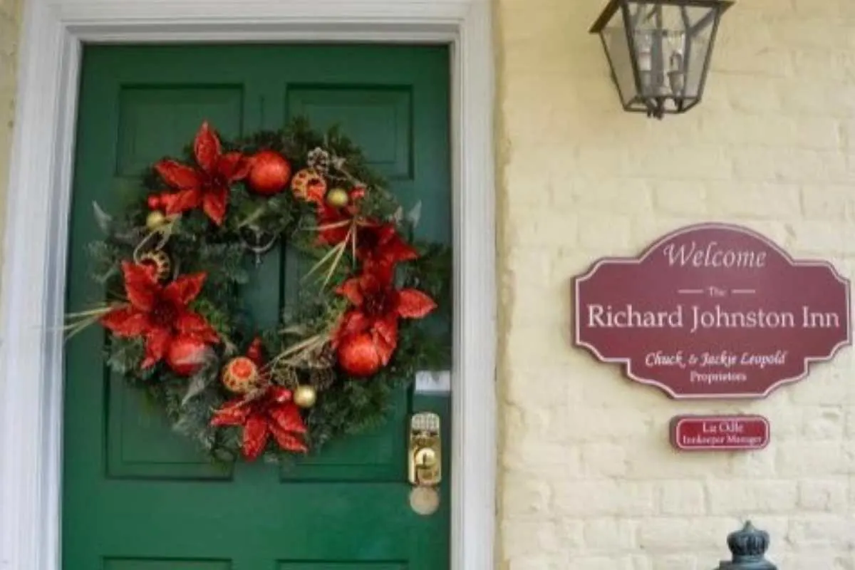 yellow house with green door and christmas wreath