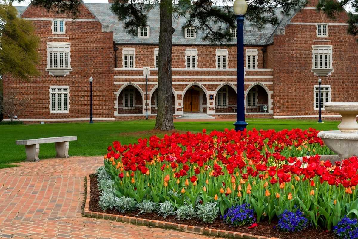 brick building on campus with sping flowers in front