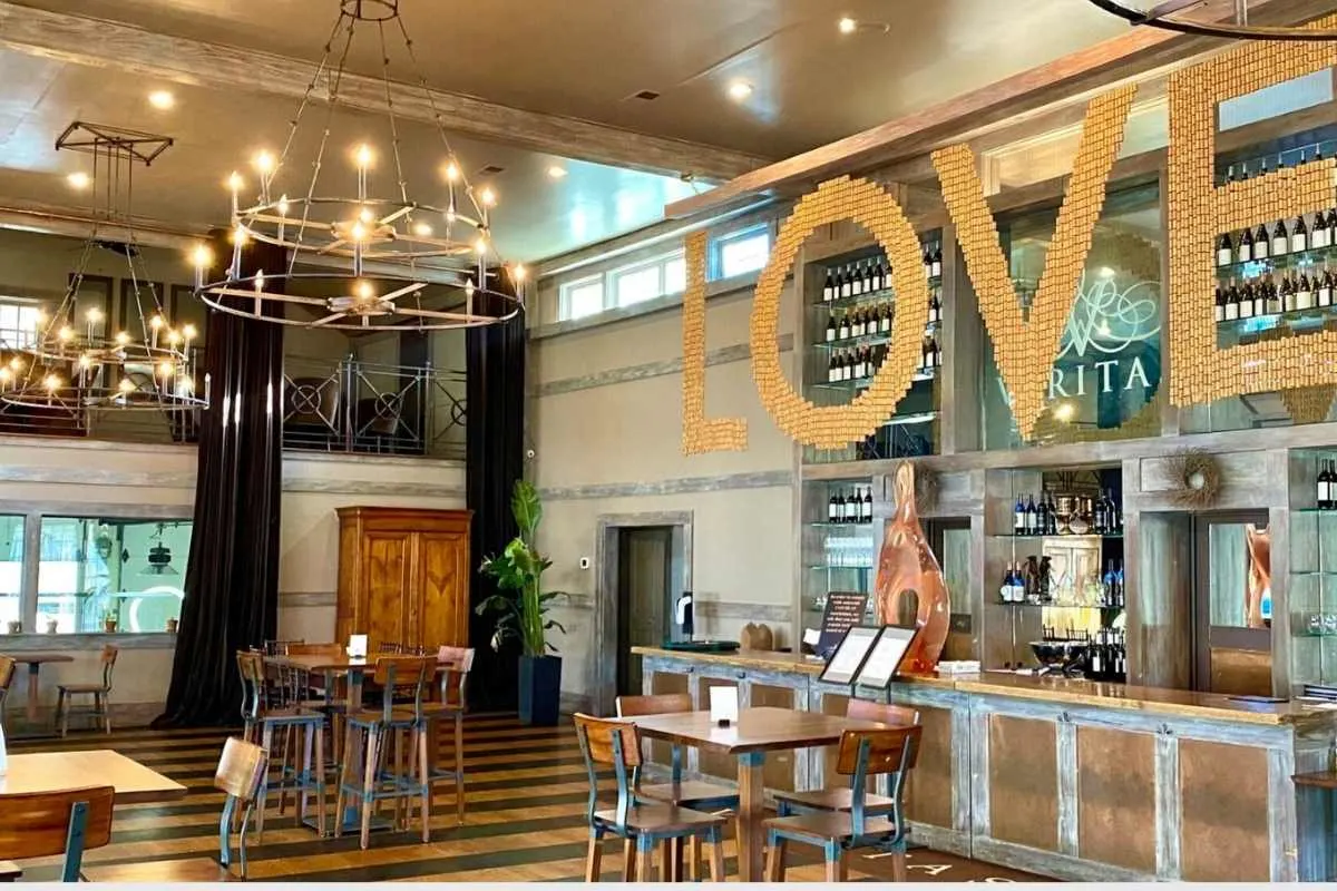 2 story room with wine bar and the word LOVE built out of corks