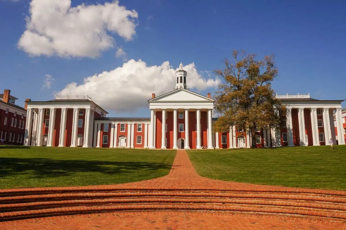 long brick neoclassical building with many white columns