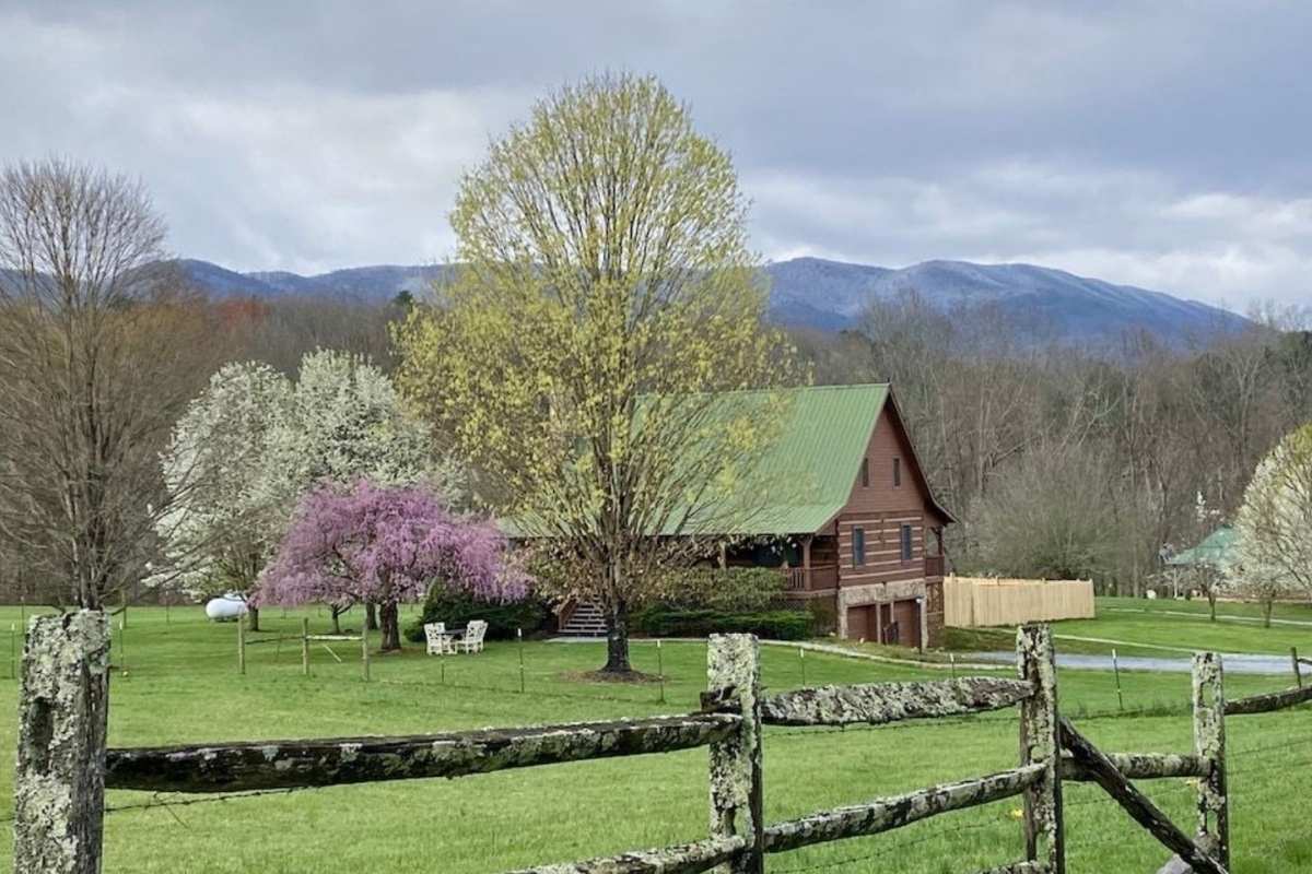 log cabin at foothills of mountains in the spring