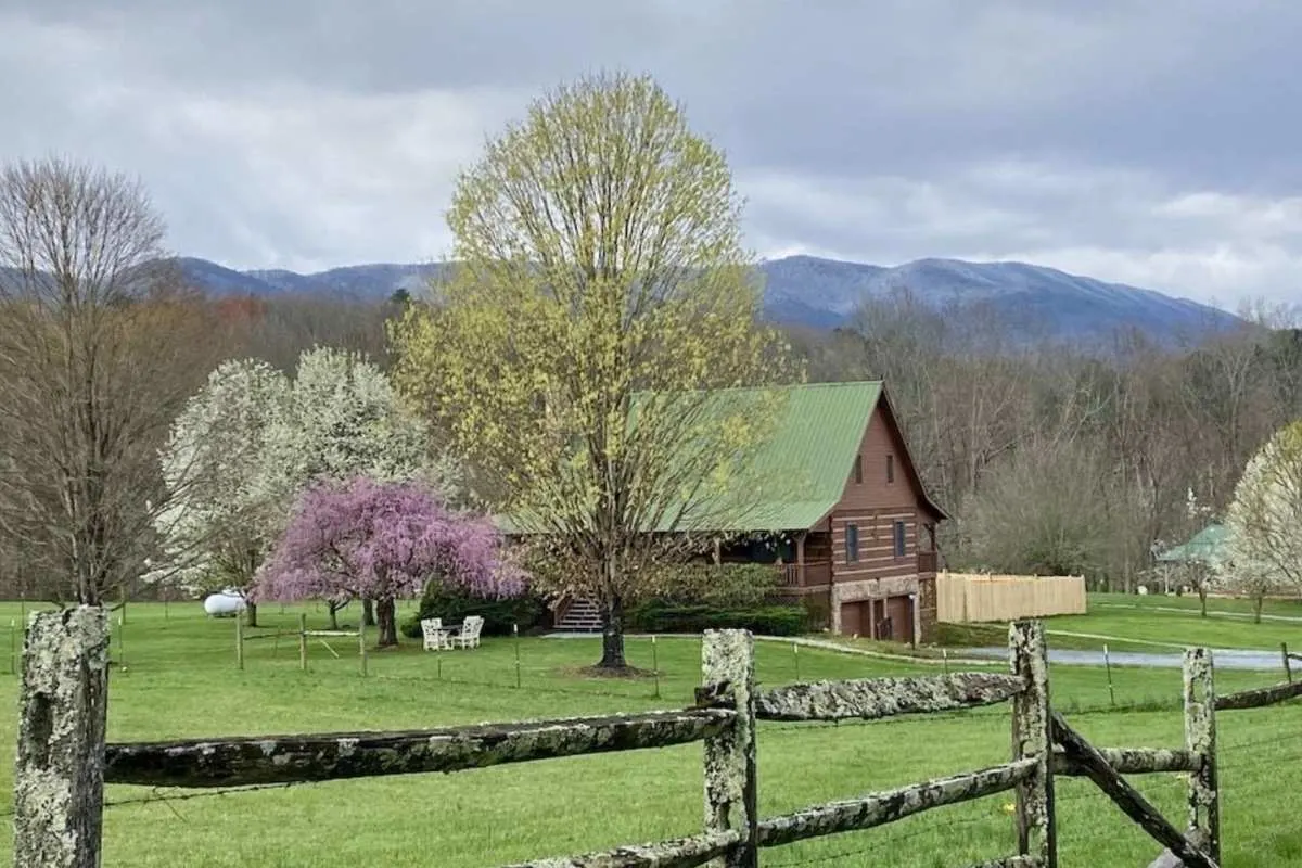 log cabin at foothills of mountains in the spring