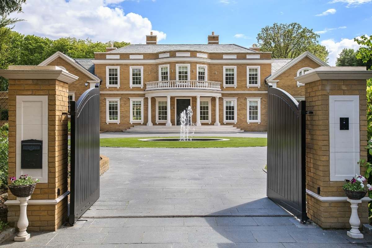 tan mansion with gate