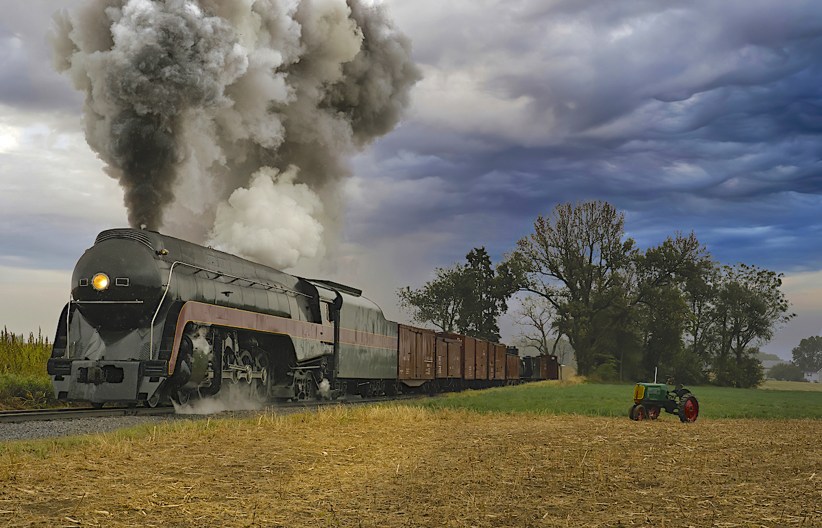 N&W Class J No. 611 Steam Locomotive rolling past farm with old tractor