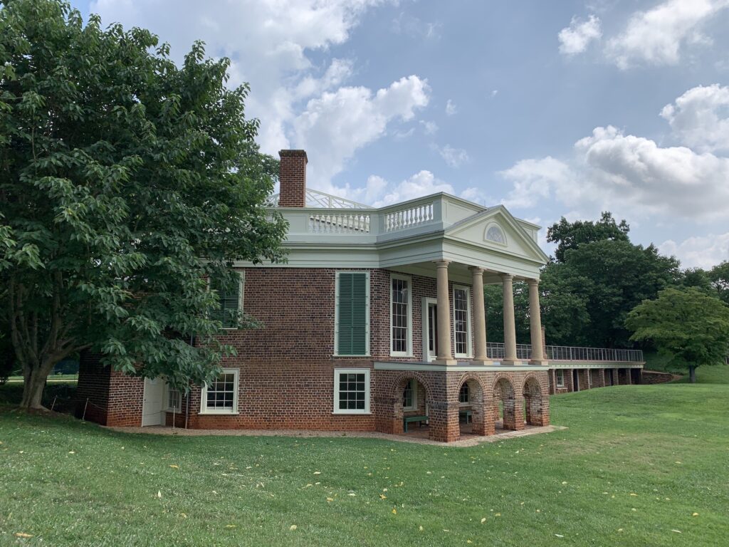 Historic Poplar Forest home perfect for day trips from Roanoke, set on a grassy field.