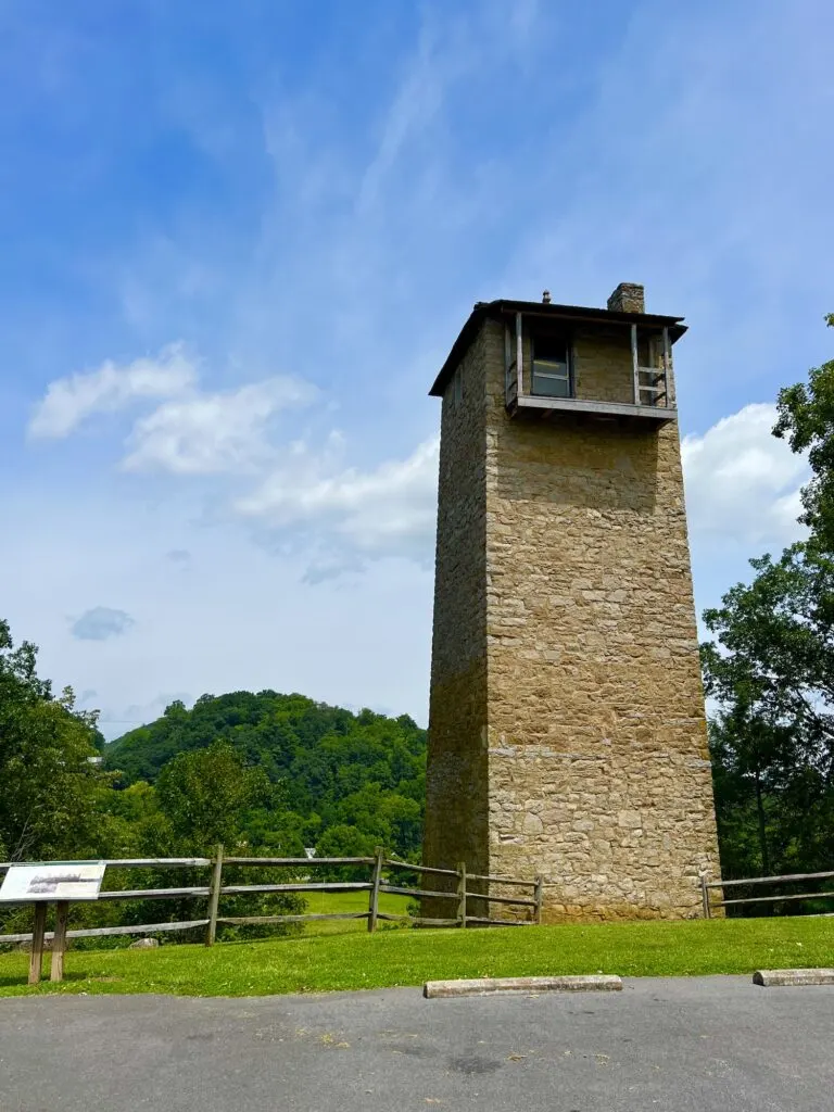 A state park with a stone tower in the middle of a grassy field, called Shot Tower State Park.