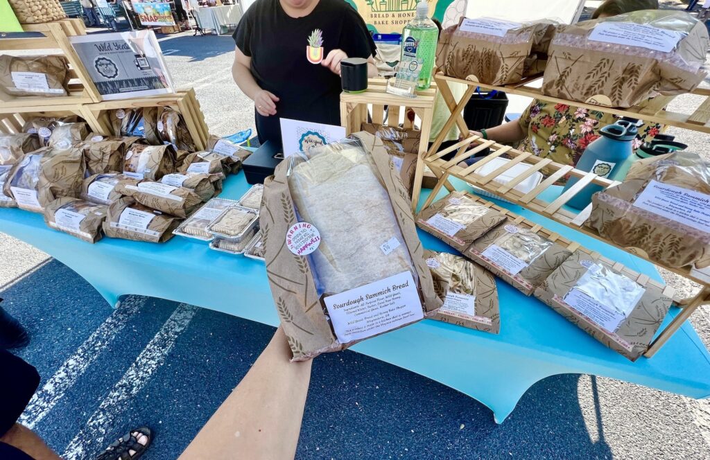 An outdoor market in Staunton featuring a person holding a bag.