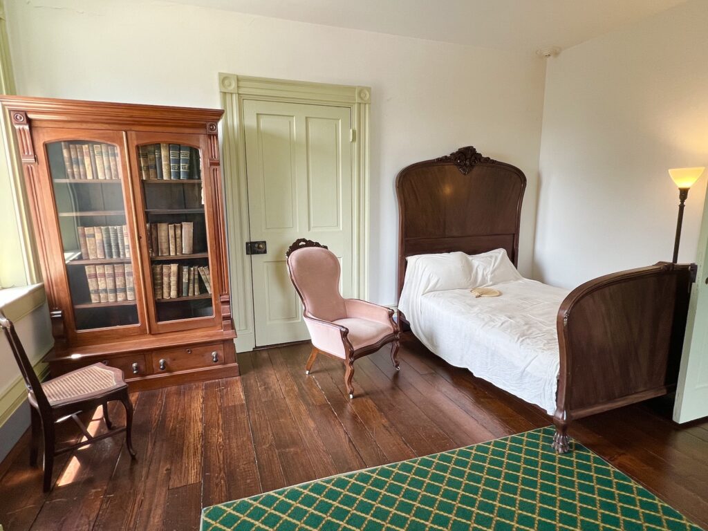 A room with a bed and a bookcase perfect for leisurely activities in Staunton.