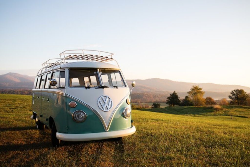 A vintage vw bus parked in a grassy field.