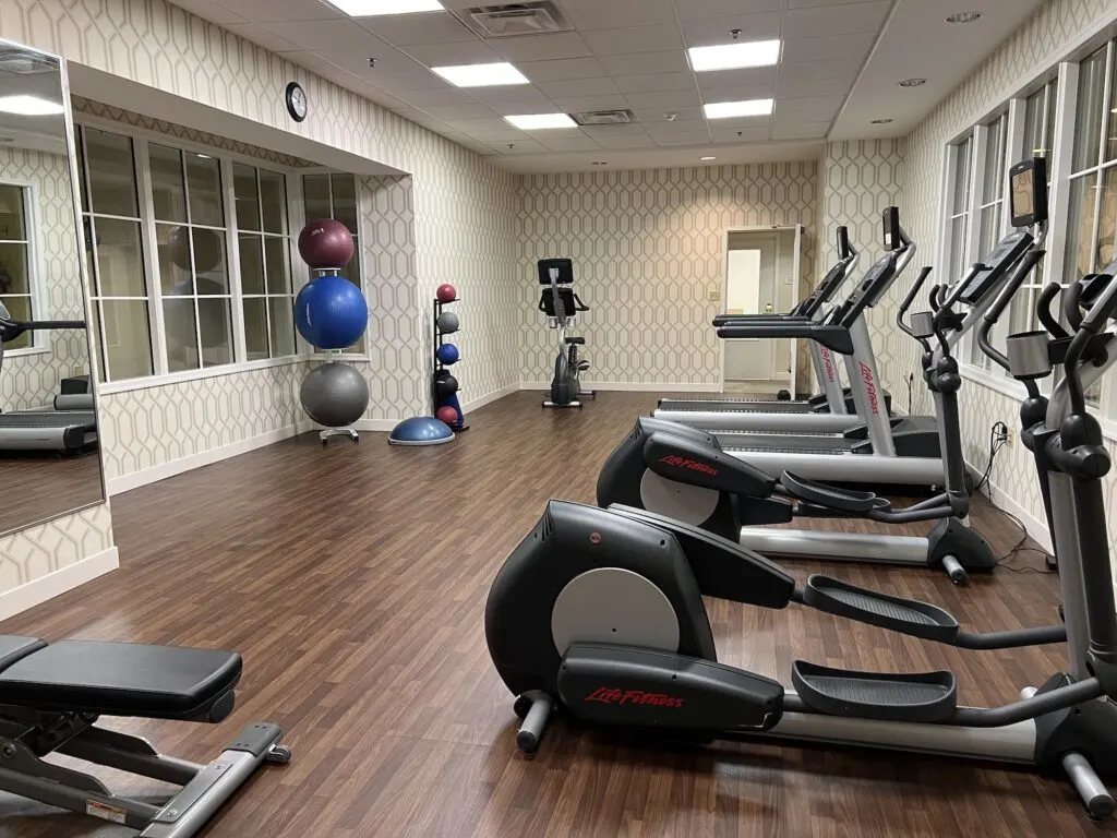 The Hotel 24 South features a modern gym room adorned with state-of-the-art exercise equipment and mirrors.