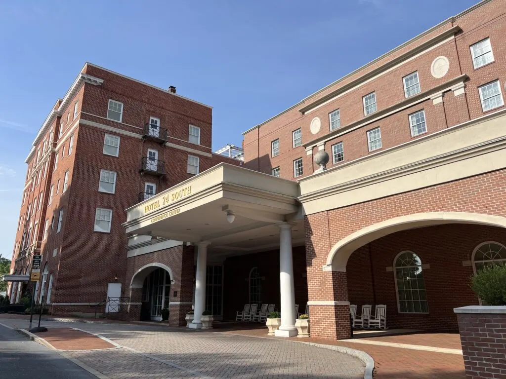 A large red brick hotel building located on 24 South.