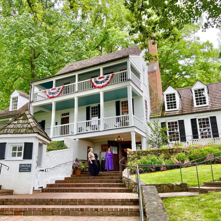 A white house with steps leading up to it.