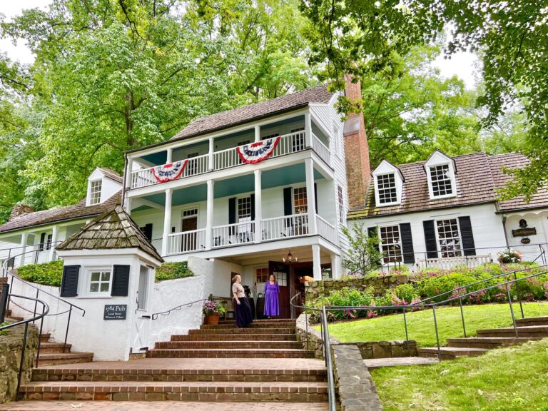 A white house with steps leading up to it.