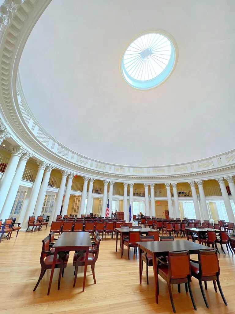 A large circular room with tables and chairs at the University of Virginia campus.
