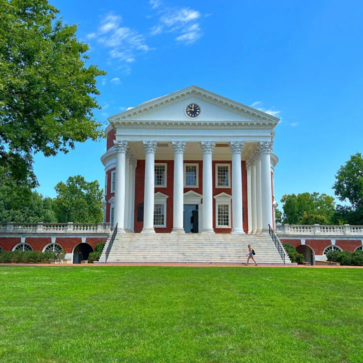 Visit the University of Virginia, a large building with columns and a green lawn.