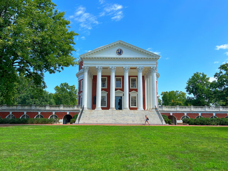 Visit the University of Virginia, a large building with columns and a green lawn.